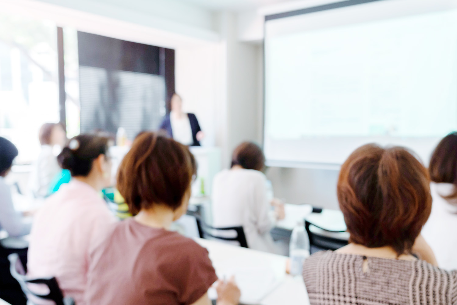 福祉施設でキーボードを弾きながら音楽療法をしている女性